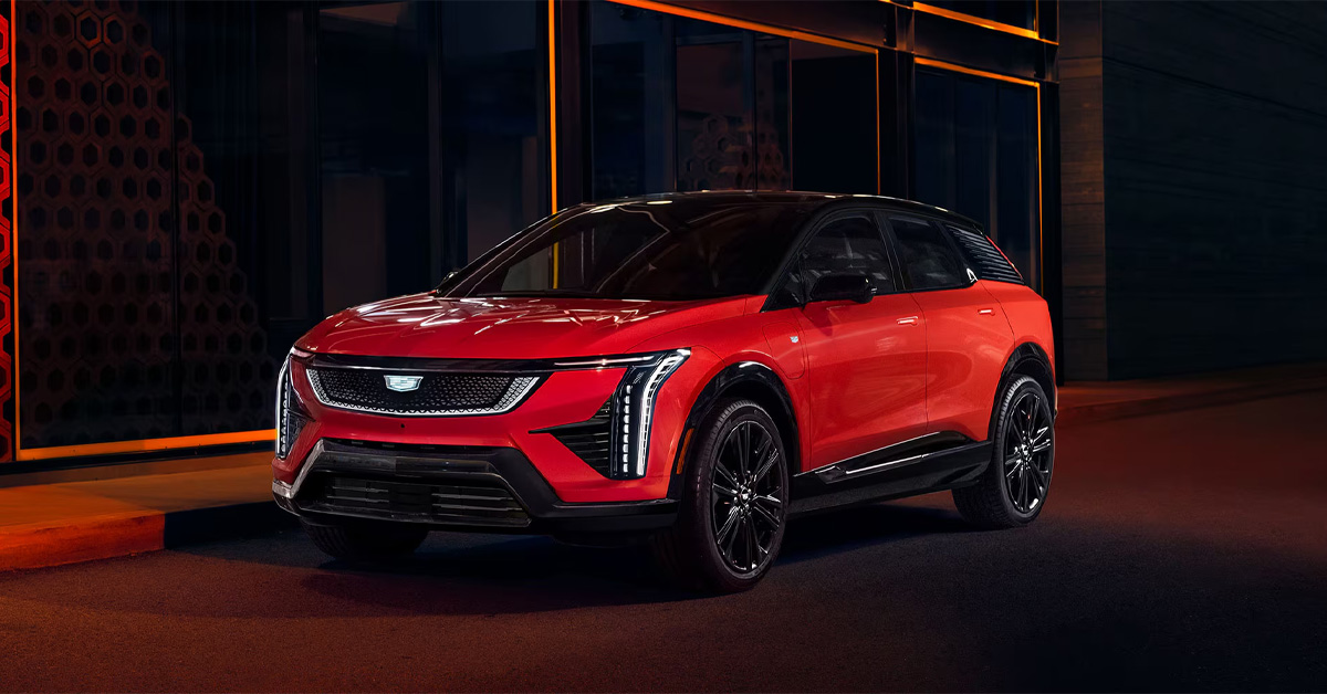 2026 CADILLAC OPTIQ parked at night in front of an establishment
