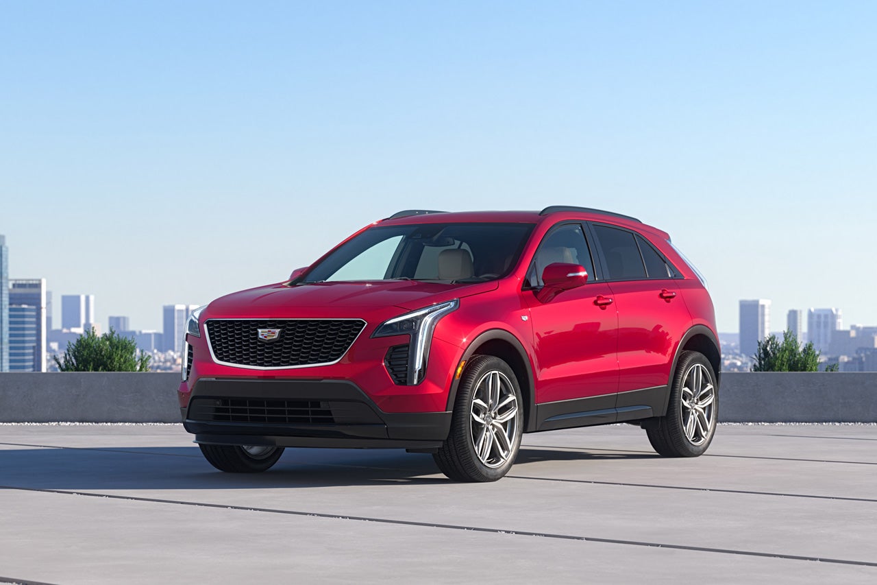 A Woman Activates the Dual Glass Power Sunroof of a 2025 Cadillac XT4 in the City